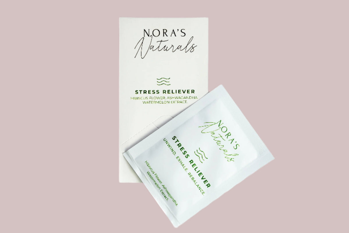 Nora&#39;s Naturals Stress Reliever product packaging on a pink background